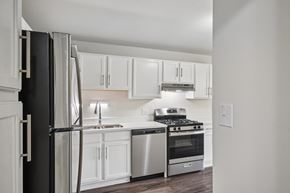 Naperville apartment for rent - A kitchen with white cabinets and stainless steel appliances.