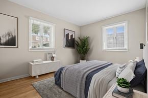 North Aurora apartment for rent - A bedroom with a bed, nightstand, and a plant.