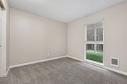 Gresham apartment for rent - A room with a carpeted floor and a window showing a view of a building outside.