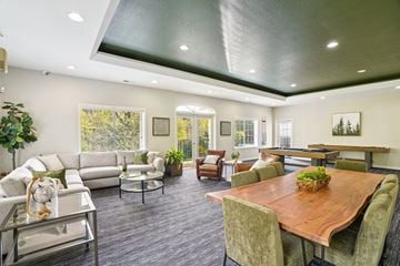 Beaverton apartment for rent - A modern living room with a wooden table and grey chairs.