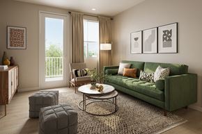Santa Paula apartment for rent - A living room with a green couch, a coffee table, and a rug.