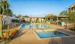 Santa Paula apartment for rent - A pool surrounded by a concrete patio and a white fence.