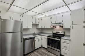Pittsburgh apartment for rent - A kitchen with white cabinets and stainless steel appliances.