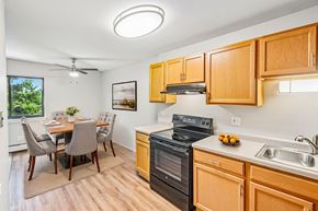 Aurora apartment for rent - A kitchen with wooden cabinets and a black oven.