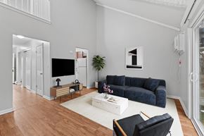 Ellington apartment for rent - A living room with a blue couch, a white coffee table, and a television.