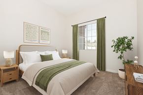 Moreno Valley apartment for rent - A bedroom with a large bed and a green plant.