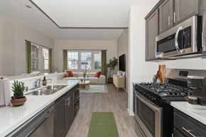 Moreno Valley apartment for rent - A modern kitchen with a stove top oven and a microwave above the counter.