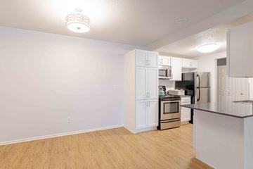 Edina apartment for rent - A kitchen with white cabinets and a black countertop.