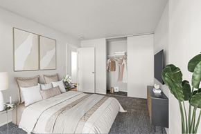 Portland apartment for rent - A bedroom with a large bed and a TV on the wall.