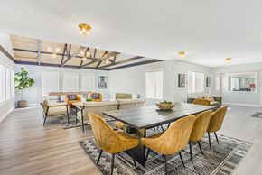 Milwaukie apartment for rent - A large room with a table and a room with a shuffleboard table in the background