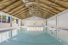 Milwaukie apartment for rent - A large indoor swimming pool with a wooden ceiling.