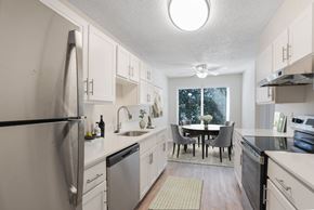 Milwaukie apartment for rent - A kitchen with a table and chairs in the middle.