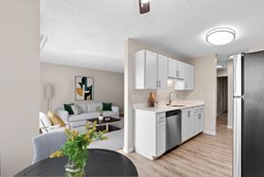 Beaverton apartment for rent - A modern kitchen with white cabinets and a black refrigerator.