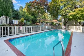 Milwaukie apartment for rent - A small pool surrounded by a fence.
