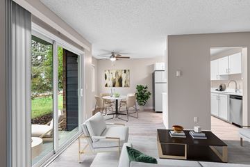 Beaverton apartment for rent - A modern living room with a sliding glass door leading to a garden.