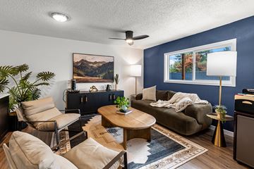Beaverton apartment for rent - A living room with a brown sofa, a wooden coffee table, and a painting on the wall.