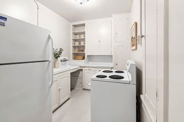 Portland apartment for rent - A white kitchen with a refrigerator, stove, and cabinets.