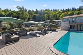 Portland apartment for rent - A wooden deck with a pool and patio furniture.