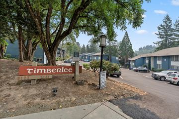 Portland apartment for rent - A Timberlee sign is in front of a tree.