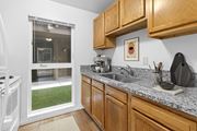 Gresham apartment for rent - A kitchen with wooden cabinets and a granite countertop.