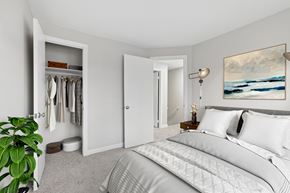 Vernon apartment for rent - A bedroom with a large bed and a painting on the wall.