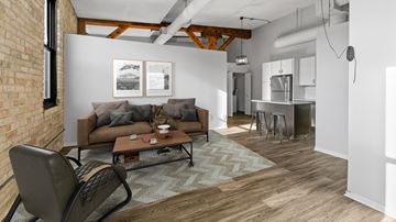 Minneapolis apartment for rent - A living room with a brown couch and a chair.