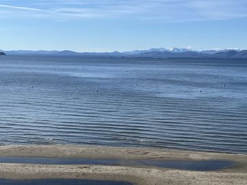 Burlington apartment for rent - A calm body of water with mountains in the distance and a clear sky.