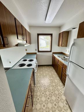Soldotna apartment for rent - A kitchen with a white fridge and a white stove top.