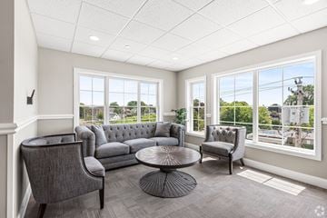 Stratford apartment for rent - a living room with couches and chairs and large windows