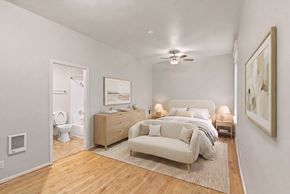 Portland apartment for rent - A bedroom with a bed, nightstand, and a couch.