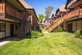 Solvang apartment for rent - apartment building with stairs and a grass yard at Oak Park Apartments, Solvang, California