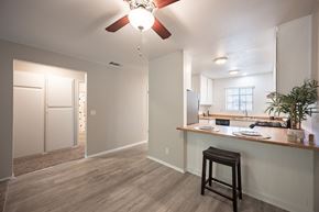 Solvang apartment for rent - kitchen and living room with a ceiling fan at Oak Park Apartments, Solvang, 93463