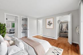 Ellington apartment for rent - A bedroom with a bed, a couch, a wardrobe, and a plant.