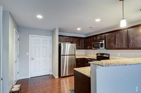 Washington apartment for rent - A kitchen with a stainless steel refrigerator and microwave.