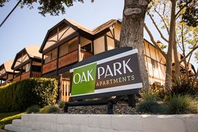 Solvang apartment for rent - a sign for oak park apartments in front of a tree at Oak Park Apartments, California