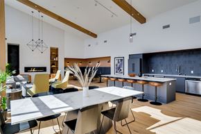 Minneapolis apartment for rent - A modern kitchen with a dining table and chairs. at Sora Apartments, Minneapolis, Minnesota