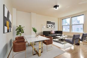 Seattle apartment for rent - A modern living room with a white table and brown chairs.