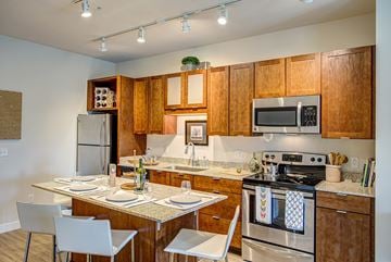 Minneapolis apartment for rent - A kitchen with wooden cabinets and a stove top oven.