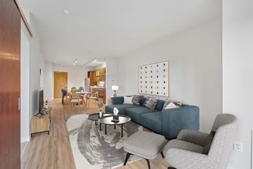Minneapolis apartment for rent - A living room with a blue couch and a television.