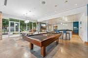 Minneapolis apartment for rent - A pool table is in the middle of a room with a bar and a television.