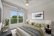 Minneapolis apartment for rent - A bedroom with a large bed and a ceiling fan.