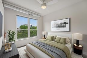 Minneapolis apartment for rent - A bedroom with a large bed and a ceiling fan.