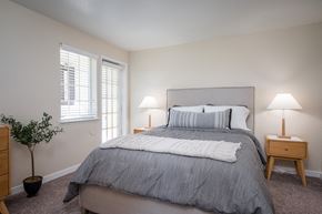 Wilsonville apartment for rent - a bedroom with a bed and two lamps and a window at Sundial Apartments, Oregon