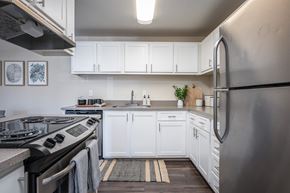 Wilsonville apartment for rent - a kitchen with white cabinets and stainless steel appliances at Sundial Apartments, Oregon, 97070