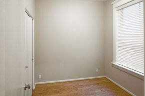 Portland apartment for rent - a bedroom with a wooden floor and a window and a door