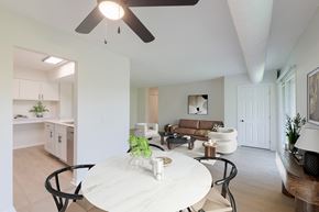 Wayzata apartment for rent - An eating area with a white table and chairs, view of the kitchen and living room