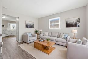Winchester townhouse for rent - A living room with a grey sofa, a wooden coffee table, and a grey rug.