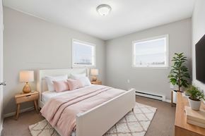 Winchester townhouse for rent - A bedroom with a bed, nightstands, and a plant.