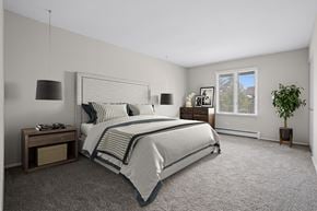 Clarendon Hills apartment for rent - A bedroom with a large bed and a potted plant.
