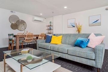 Oak Park apartment for rent - A living room with a blue couch and a glass coffee table.